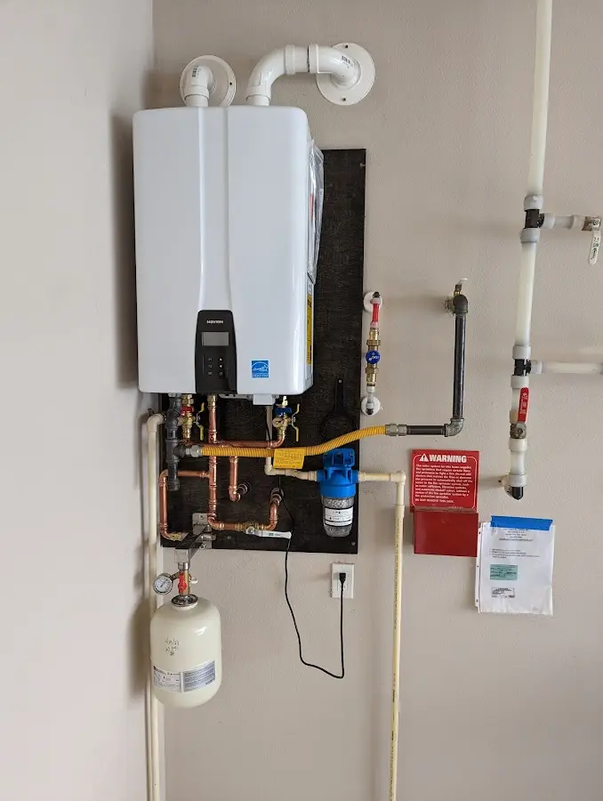 Professional plumber installing copper piping in a Travilah home